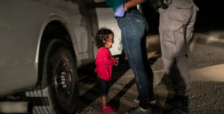 World Press Photo of the Year, Winner - Crying Girl on the Border” © John Moore, Getty Images Immigrant families had rafted across the Rio Grande from Mexico and were detained by the authorities. Yana (who was approaching her second birthday) and her mother had been part of a refugee caravan that started its journey in southern Mexico in April. Yana, from Honduras, cries as her mother Sandra Sanchez is searched by a US Border Patrol agent, in McAllen, Texas, USA, on 12 June.