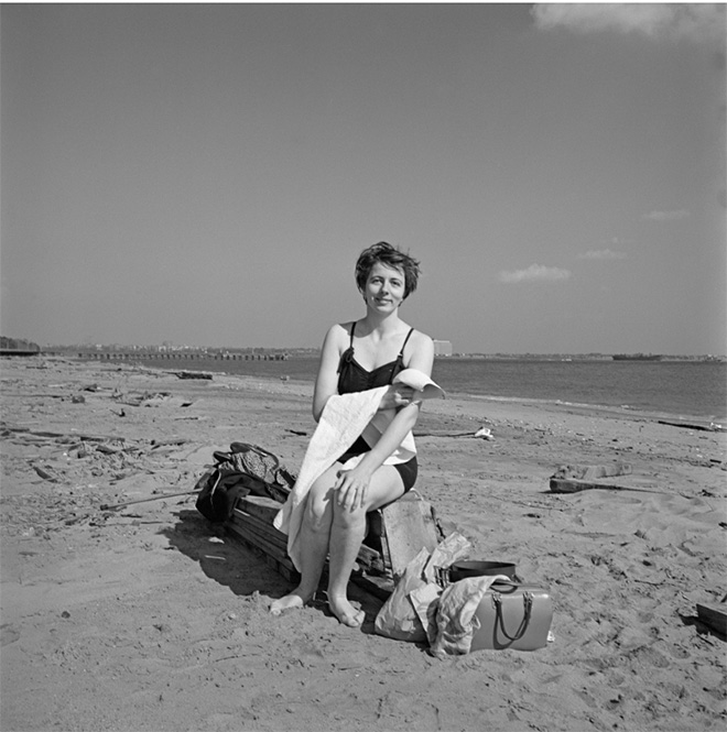 Self-portrait on a beach in New York's Staten Island, 1954. Image size: 12x12 inch (30,48 x 30,48 cm) Paper size: 20x16 inch (50,8 x 40,64 cm) ©Estate of Vivian Maier, Courtesy of Maloof Collection and Howard Greenberg Gallery, NY