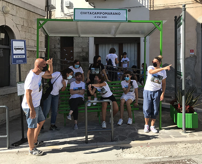 Biancoshock - (A Via Nov), Cvtà Street Fest 2020, Civitacampomarano. Photo credit: Giorgio Coen Cagli. People from Civita are finally waiting for the bus at the bus-stop created by Biancoshock. It was removed in 2011, without being replaced by a new one.