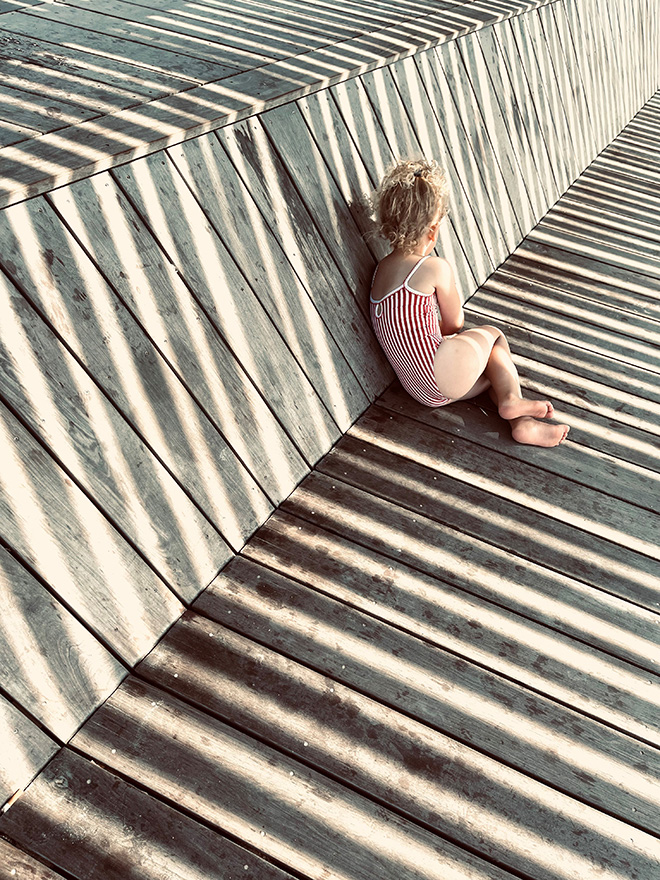 © Anne Ziolo - IPPAWARDS, France. 3rd Place – Children. In the Shade of the Stripes | Shot on iPhone 12 Pro Max, Carnac, France.