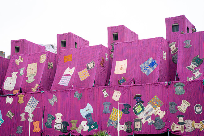 Ibrahim Mahama’s Purple Hibiscus during installation at the Barbican, 2024. Courtesy Ibrahim Mahama, Red Clay Tamale, Barbican Centre, London and White Cube.  © Pete Cadman, Barbican Centre.