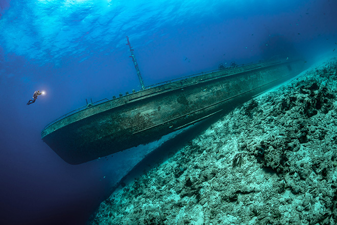 Tobias Friedrich - A scuba diver is dwarfed by a shipwreck. The Bahamas. Winner Ocean Adventure Photographer of the Year