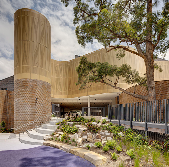 fjcstudio architecture - Darlington Public School, Sydney. Seating bleachers blend smoothly into embankment with associated planting. Photo credit: Brett Boardman