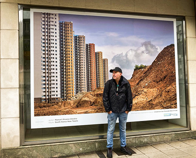 Manuel Alvarez Diestro - The artist in front of South Korea New Towns, installation view, Santander